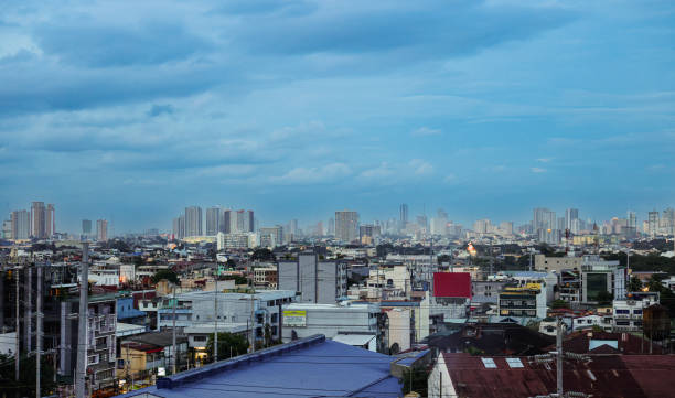 Manila, Philippines - November 6, 2024: Beautiful twilight view of Manila skyline filled with buildings and a vibrant atmosphere beneath a cloudy sky.