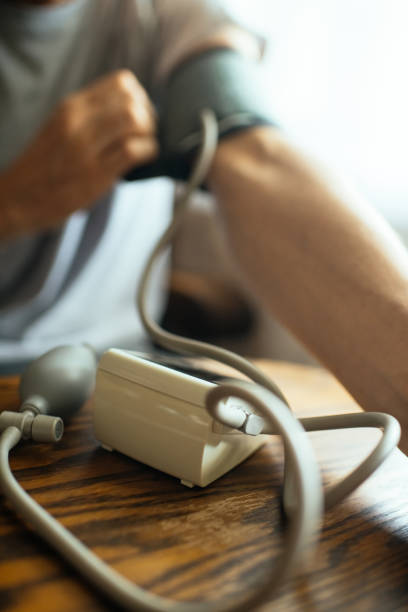 istock Senior man measuring blood pressure at home 2199545824