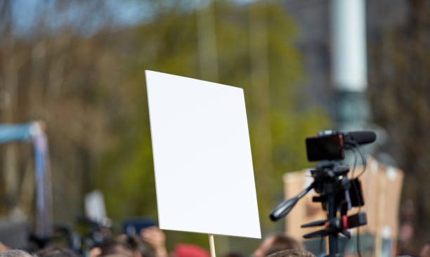 istock Protesters holding placards and signs on the streets. 2199546039