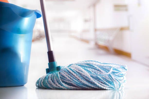 Mop and bucket on clean floor in a white corridor stock photo