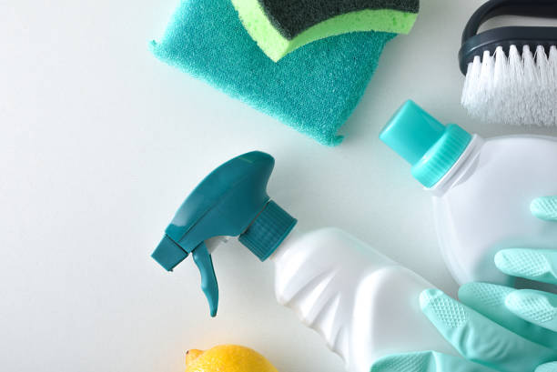 istock Cleaning products in green tones on white bench top view 2199549656