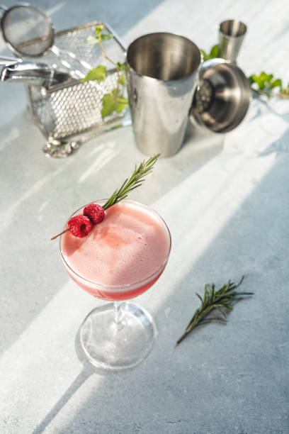 istock Refreshing pink cocktail garnished with raspberries and rosemary 2199553115