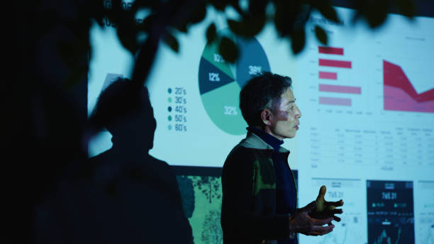 istock Senior Executive Discusses Sustainability Goals in a Darkened Office 2199553202