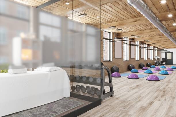 istock Contemporary Pilates Studio With Exercise Balls and Massage Table by a Glass Partition 2199554205