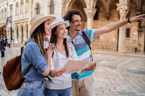istock Tourists exploring Dubrovnik with map and pointing at landmark 2199556461