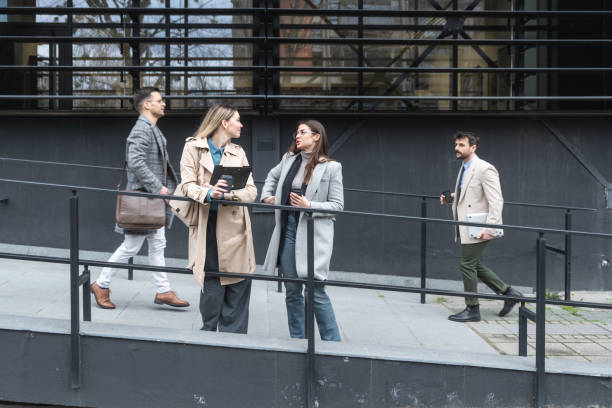 istock Professional occupation, office workers. Business people meet before staff meeting and presentation in office building, to talk and discus plans and tactic of speech theme. Finance and economy. 2199559496