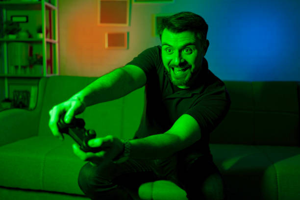 istock Enthusiastic Gamer Immersed in Colorful Gaming Experience 2199560425