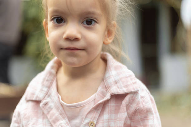 istock Little girl portrait, looking at camera with hope 2199560431