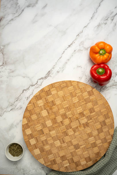 istock Wooden cutting board on marble countertop 2199566152