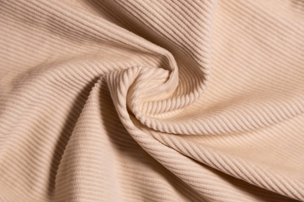 istock Velvety fabric texture pattern. Texture of velvet textile nude color. 2199566638