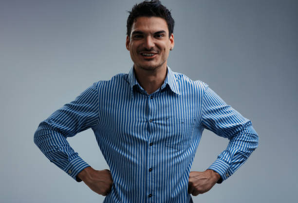 istock Confident businessman smiling with hands on hips: studio portrait 2199568388