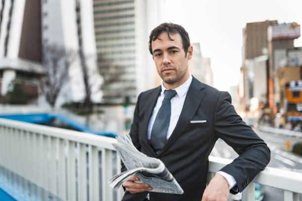 istock caucasian business man portrait with newspaper 2199570978
