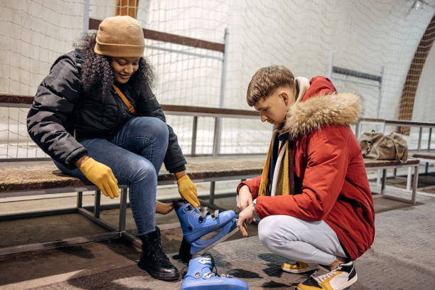 istock Friends preparing for ice skating changing shoes 2199571719