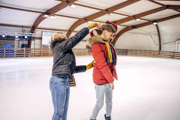 istock Friends having fun ice skating together trying to dance 2199571971