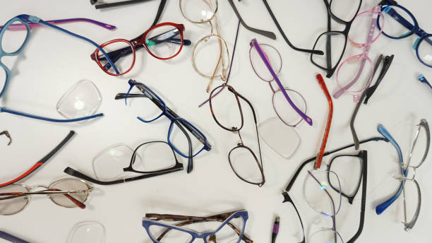 istock Assortment of broken optical eyeglasses, broken hinges, missing lenses 2199572527