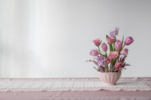 istock pink flowers in vase on background white wall 2199572738