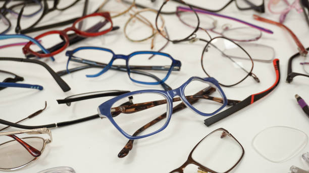 istock Assortment of broken optical eyeglasses, broken hinges, missing lenses 2199572936
