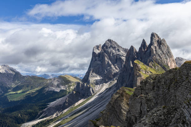 istock Seen from a new perspective, Seceda sharp ridges rise above shadowed slopes and vibrant valleys, framed by a mix of sunlight and clouds 2199576227
