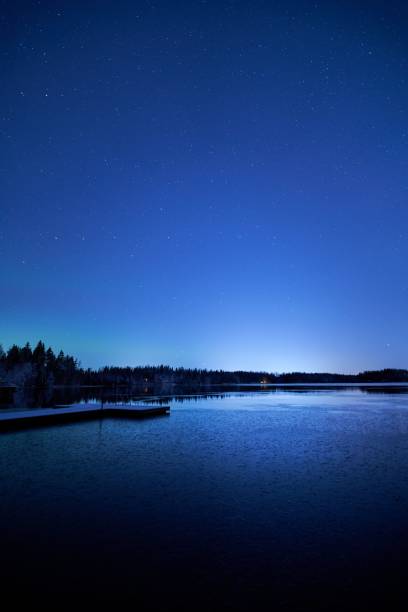 istock Serene night landscape of a lake under a starry sky. 2199577792