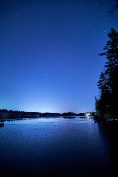 istock Serene night sky over a calm lake 2199577810