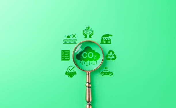 istock Reducing CO2 emissions and sustainability concept. CO2 cloud surrounded by green energy and sustainability icons on background, carbon footprint reduction, renewable energy, environmental conservation 2199581911