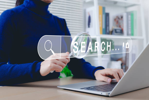 istock SEO search engine optimization concept. Woman using laptop, holding magnifying glass, symbolizing online search and SEO. Search bar represents internet browsing, keyword analysis, digital marketing, 2199581947