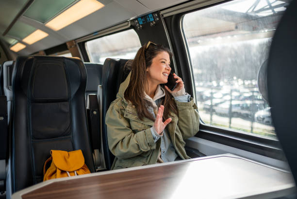 istock Woman having a phone call while traveling by train 2199582500