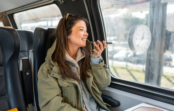 istock Woman sending a voice message while riding a train 2199582513
