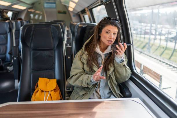 istock Woman sending a voice message while riding a train 2199582571