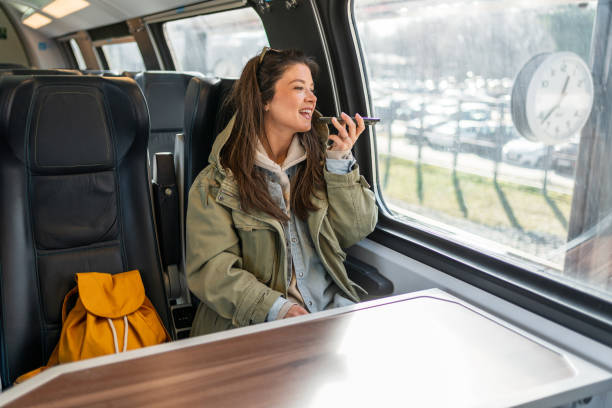 istock Woman sending a voice message while riding a train 2199582825