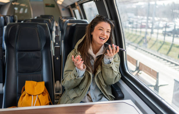 istock Woman sending a voice message while riding a train 2199582841
