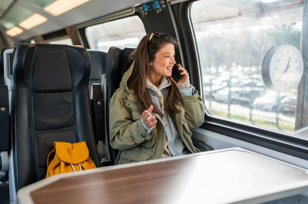 istock Woman having a phone call while traveling by train 2199582896