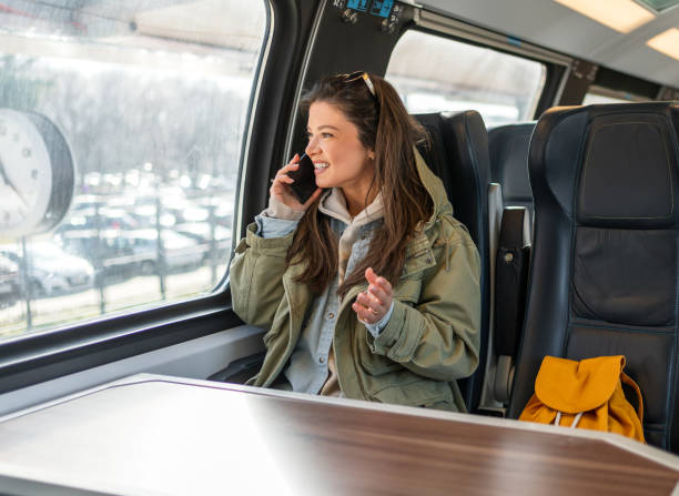 istock Woman having a phone call while traveling by train 2199582922