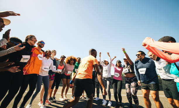 istock Energetic team leader hyping up members before a run 2199583216