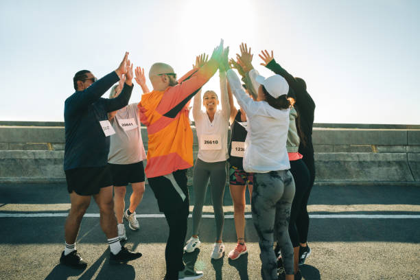 istock Group of runners cheering and supporting each other outdoors 2199584168