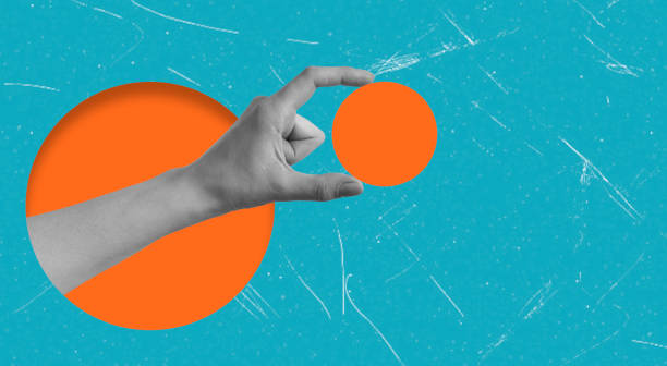 istock Modern art collage featuring a hand holding an orange circle on a blue background. 2199584880