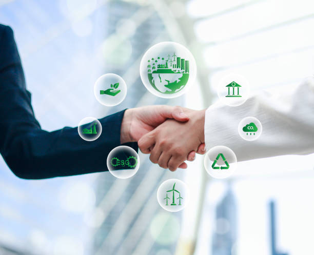 istock Business partners colleagues on World Environment Day shaking hands during meeting to work together for sustainability. Green concept with Co2 icon. 2199586319