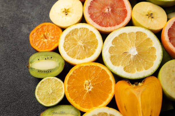 istock A close up of many different types of fruit, including oranges, kiwis, and apples 2199587521