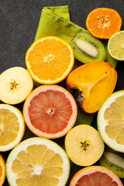 istock A bunch of fruit including oranges, kiwis, and grapefruit are displayed on a green cloth 2199587535
