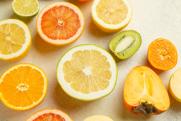 istock A close up of various types of fruit, including oranges, grapefruit, kiwi, and apples 2199587568