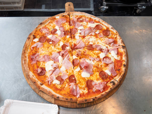Delicious Pepperoni and Ham Pizza on Wooden Platter