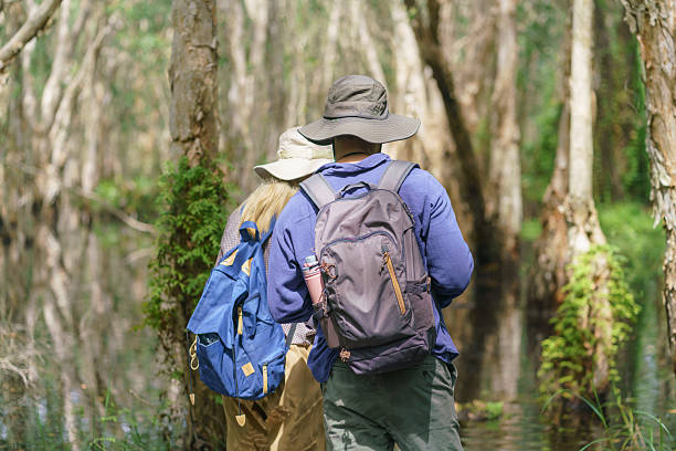 istock A male and female biologist uses binoculars and laptops to survey and document the diversity of plants and organisms in a peat swamp forest. 2199592017