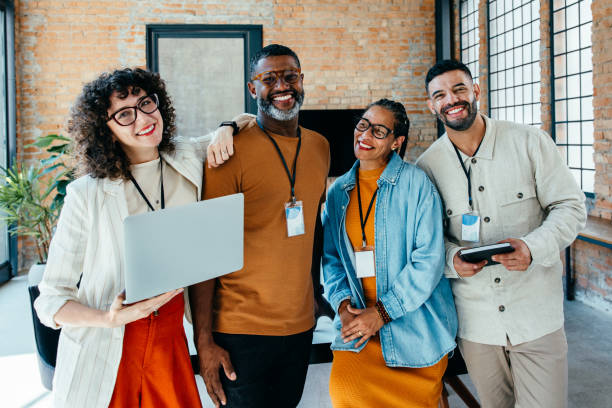 istock Smiling diverse team of professionals collaborating in a modern office environment 2199593242