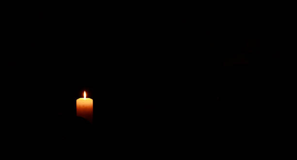 candle light narrow focus religion concept black dark background wallpaper empty copy space advertising poster pattern for text here