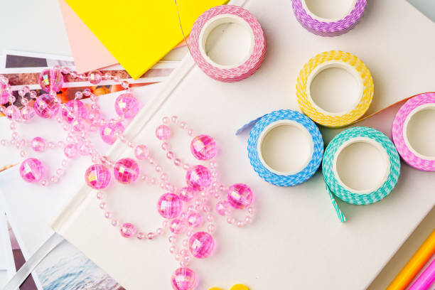 istock Colorful craft supplies including decorative tape and beads on a creative workspace in daylight 2199597447