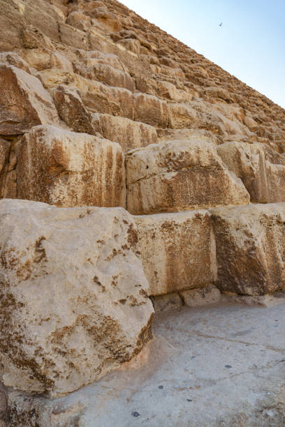 istock Exploring the ancient stone steps of the Great Pyramid near Giza under a clear blue sky 2199597540