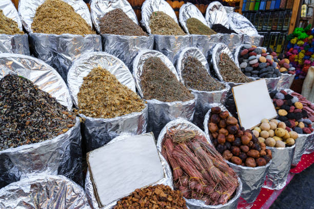 Colorful array of spices displayed in market with vibrant textures and rich aromas in an outdoor shopping environment