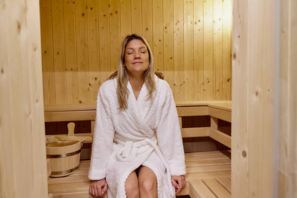 istock Smiling woman enjoying in her time at the sauna. 2199599716