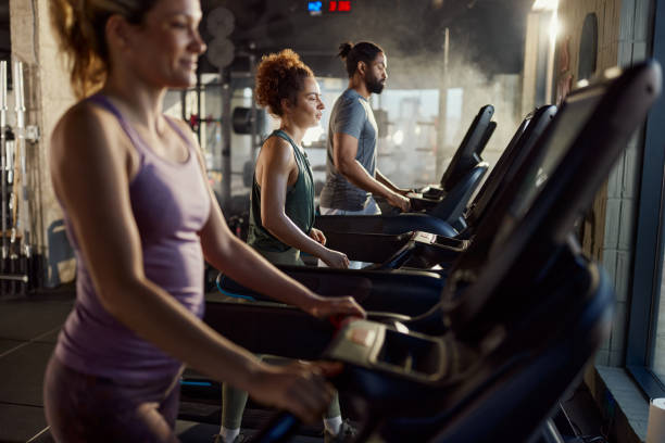 istock Athletic people warming up on treadmills in a gym. 2199600663