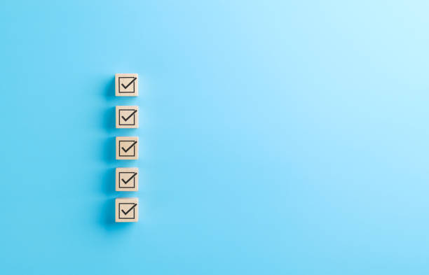 istock Checklist concept. Correct sign tick checkmark on wooden block with copy space for the checklist on light blue background. Business survey questionnaire, Exam test process, filling digital form online 2199600761